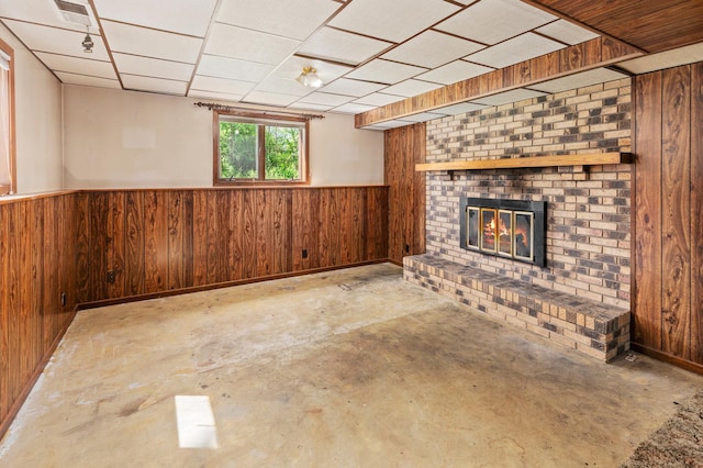 409 Dale Dr SE, Remer, MN 56672 - basement featuring wood walls, a wainscoted wall, and a fireplace