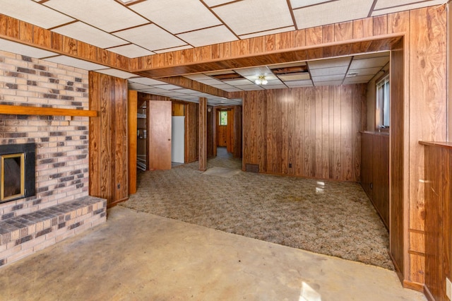 409 Dale Dr SE, Remer, MN 56672 - basement featuring wooden walls, a brick fireplace, and carpet floors
