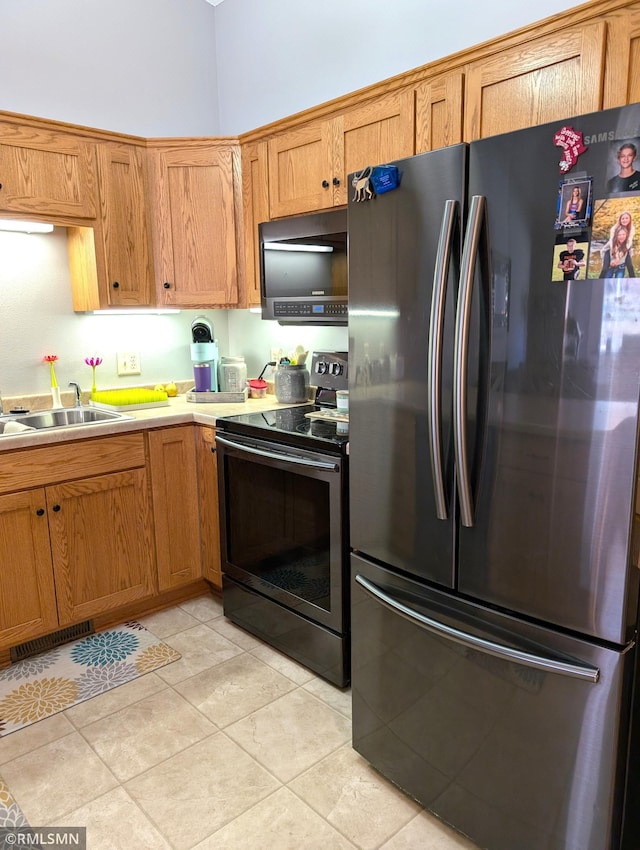 902 Meadow Lark Ln, Long Prairie, MN 56347 - kitchen with stainless steel appliances, brown cabinets, and light countertops