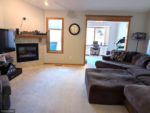 902 Meadow Lark Ln, Long Prairie, MN 56347 - living room featuring a desk, carpet flooring, plenty of natural light, and baseboards