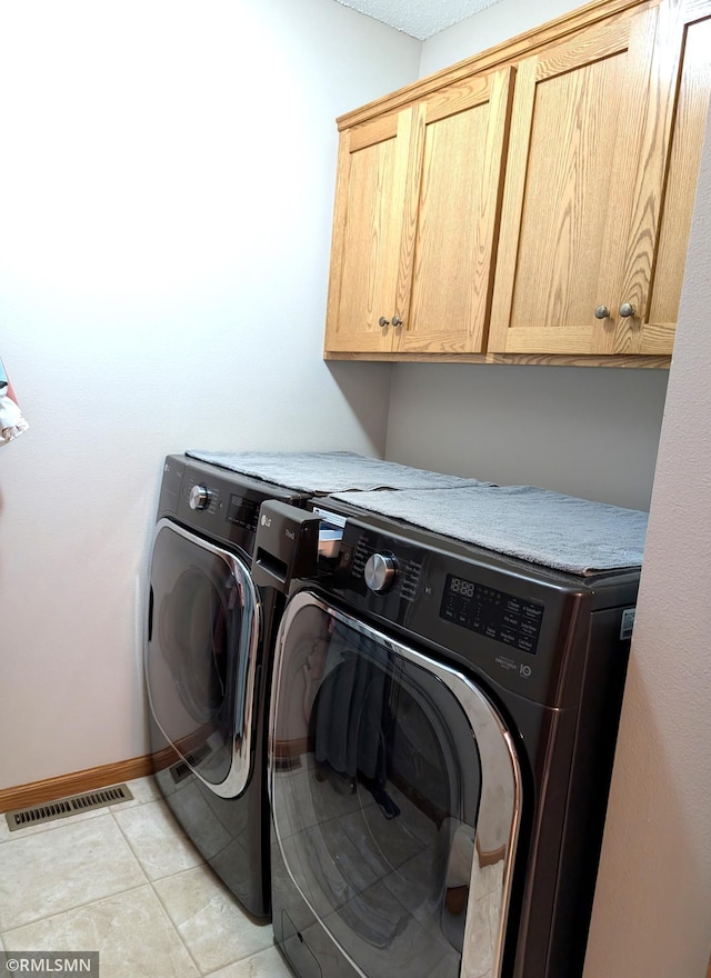 902 Meadow Lark Ln, Long Prairie, MN 56347 - laundry room with cabinet space, independent washer and dryer, baseboards, and light tile patterned floors