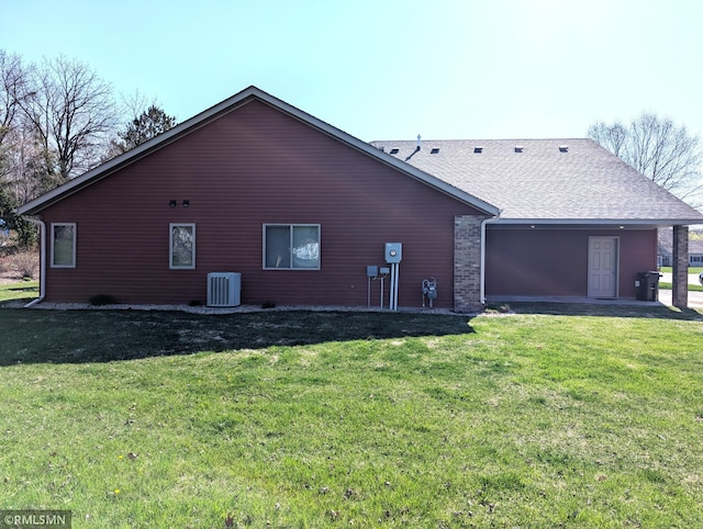 902 Meadow Lark Ln, Long Prairie, MN 56347 - view of side of property featuring central AC unit, a yard, a shingled roof, and an attached garage