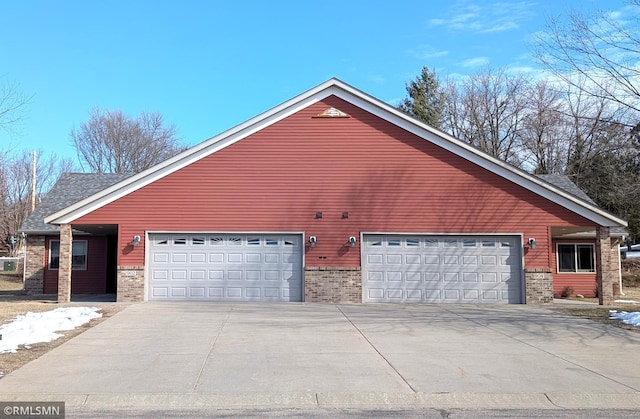 902 Meadow Lark Ln, Long Prairie, MN 56347 - view of home's exterior featuring brick siding, concrete driveway, and a garage