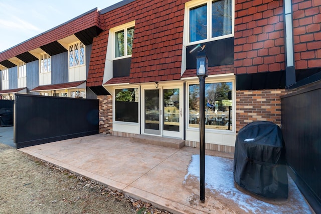 back of property featuring a patio area and brick siding