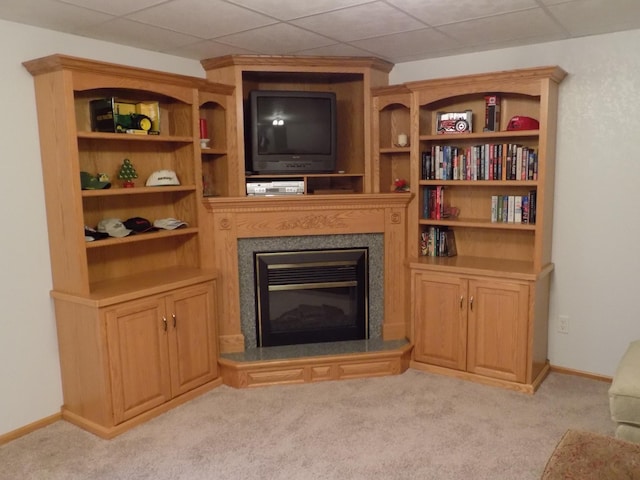 living area with a fireplace, carpet flooring, and baseboards
