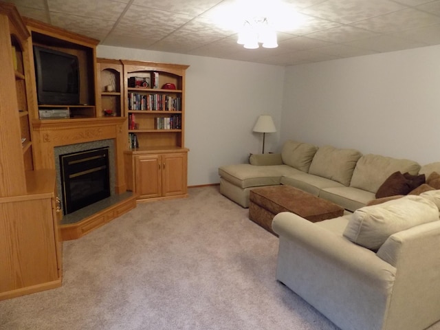 living room featuring light colored carpet and a glass covered fireplace