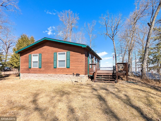 view of side of property with a wooden deck