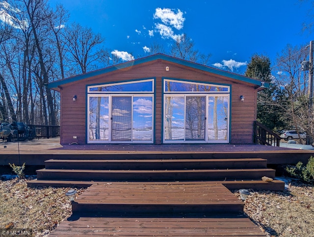 rear view of house with a wooden deck