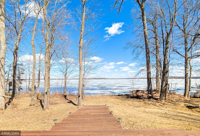 wooden terrace with a boat dock and a water view