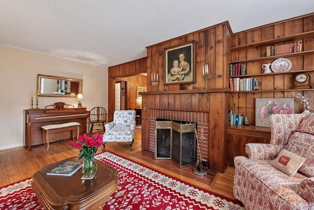 19135 Highland Ave, Deephaven, MN 55391 - living room featuring wood finished floors, wood walls, and a fireplace