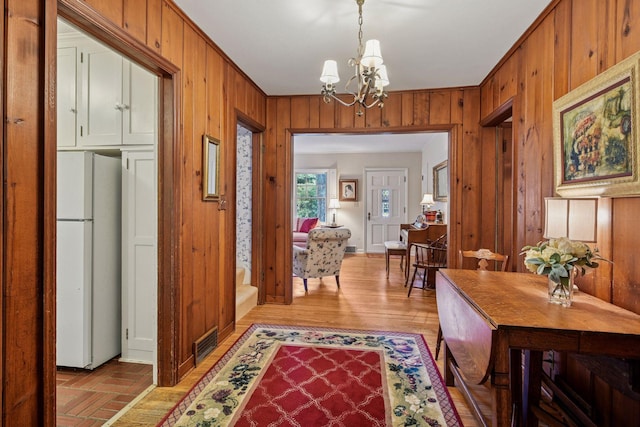 19135 Highland Ave, Deephaven, MN 55391 - entryway featuring wooden walls and a chandelier