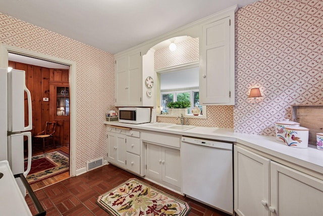 19135 Highland Ave, Deephaven, MN 55391 - kitchen featuring white appliances, wallpapered walls, light countertops, and white cabinets