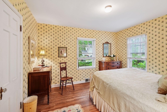 19135 Highland Ave, Deephaven, MN 55391 - bedroom with wallpapered walls and wood finished floors