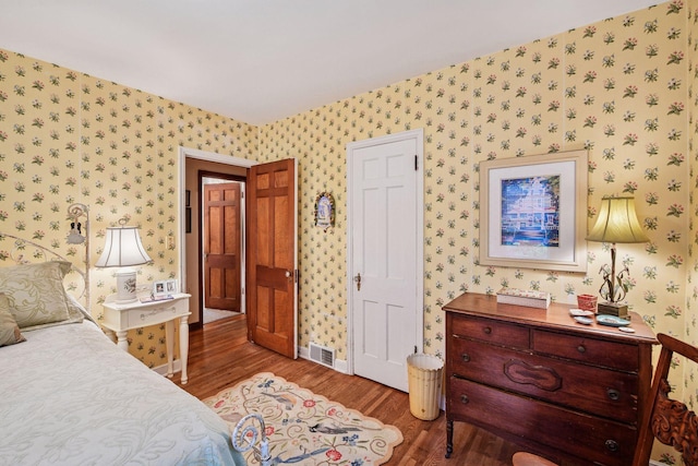 19135 Highland Ave, Deephaven, MN 55391 - bedroom featuring wallpapered walls and wood finished floors