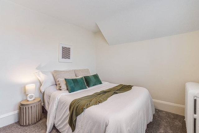 carpeted bedroom featuring baseboards and radiator