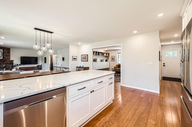 7488 Hydram Ave S, Cottage Grove, MN 55016 - kitchen with dishwasher, white cabinetry, light wood-style floors, open floor plan, and light stone countertops