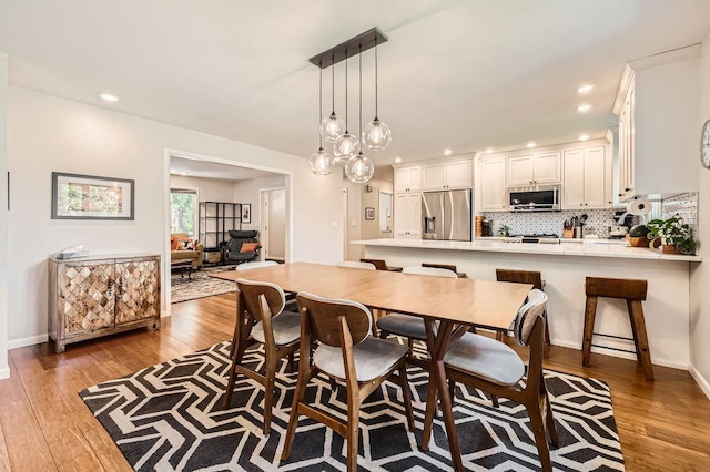 7488 Hydram Ave S, Cottage Grove, MN 55016 - dining room with hardwood / wood-style floors, recessed lighting, and baseboards