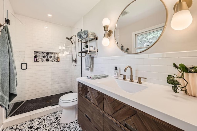 7488 Hydram Ave S, Cottage Grove, MN 55016 - bathroom featuring toilet, a shower stall, vanity, tile walls, and tile patterned floors