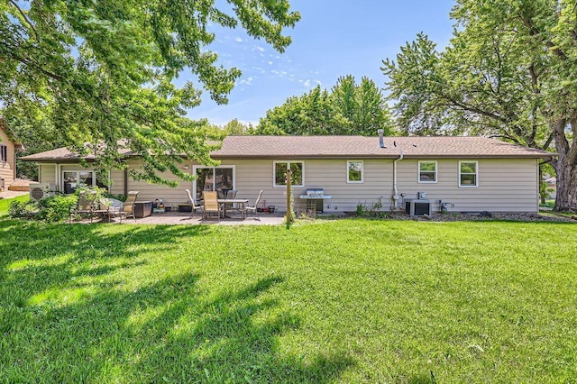 7488 Hydram Ave S, Cottage Grove, MN 55016 - rear view of property with central AC, a patio area, and a lawn