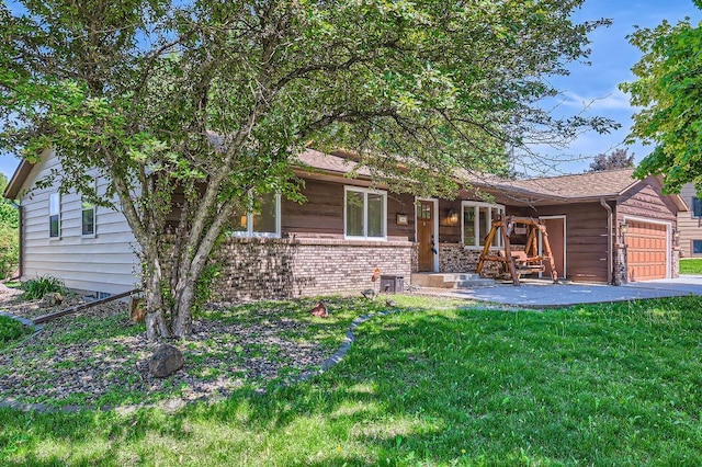 7488 Hydram Ave S, Cottage Grove, MN 55016 - view of front facade featuring a garage, a front yard, a porch, and brick siding