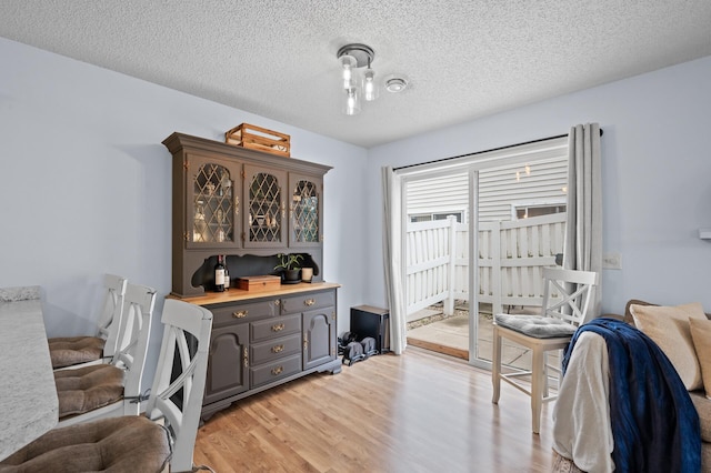1324 Pembrooke Ln, Waconia, MN 55387 - dining space featuring light wood finished floors and a textured ceiling