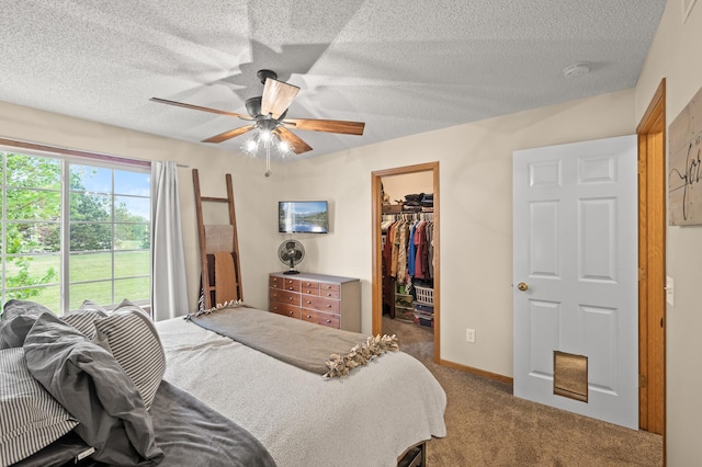 1324 Pembrooke Ln, Waconia, MN 55387 - bedroom with a walk in closet, carpet floors, a textured ceiling, a closet, and ceiling fan
