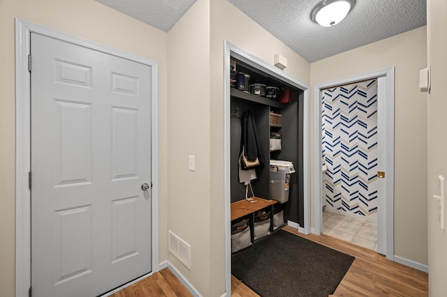 1324 Pembrooke Ln, Waconia, MN 55387 - mudroom featuring a textured ceiling and wood finished floors