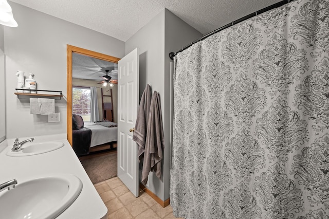 1324 Pembrooke Ln, Waconia, MN 55387 - ensuite bathroom featuring double vanity, a textured ceiling, and curtained shower