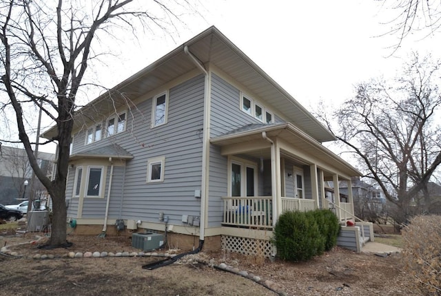 view of side of home featuring a porch and central air condition unit