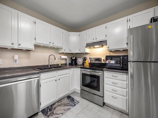 11004 Oregon Curv, Bloomington, MN 55438 - kitchen featuring stainless steel appliances, under cabinet range hood, dark countertops, white cabinetry, and a textured ceiling