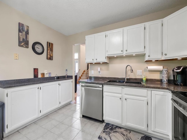 11004 Oregon Curv, Bloomington, MN 55438 - kitchen featuring appliances with stainless steel finishes, white cabinets, light tile patterned flooring, and a textured ceiling