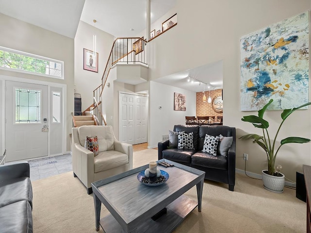 11004 Oregon Curv, Bloomington, MN 55438 - living room with stairs, a high ceiling, track lighting, and light colored carpet