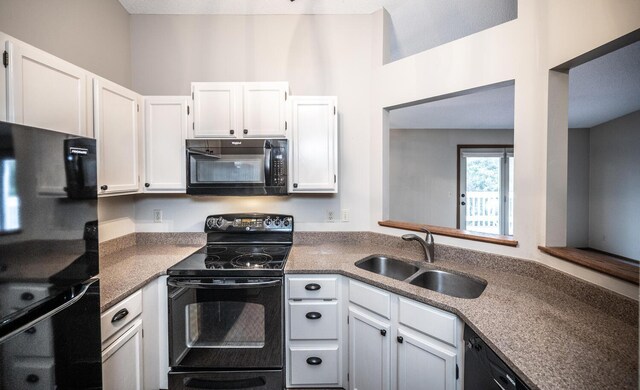 kitchen featuring white cabinets, black appliances, and a sink