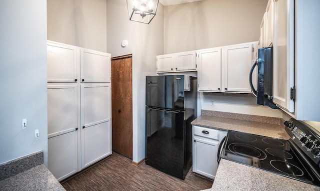 kitchen with black appliances and white cabinets