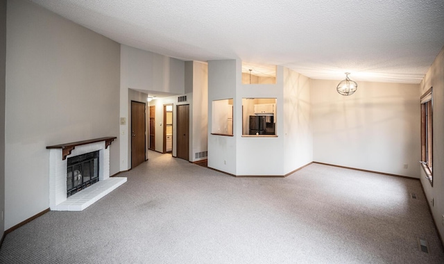 unfurnished living room with visible vents, baseboards, carpet floors, and a fireplace