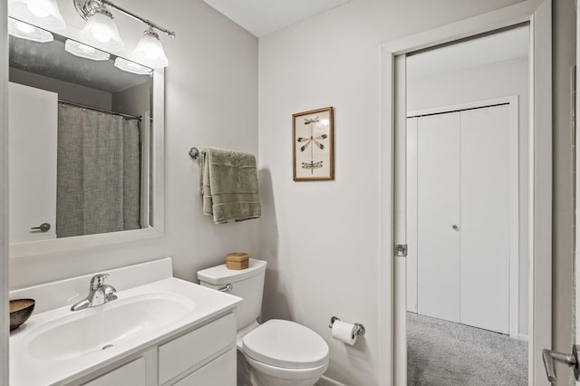 bathroom with toilet and vanity