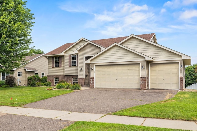 367 Garden Dr, Delano, MN 55328 - view of front of house with brick siding, asphalt driveway, a front lawn, a garage, and a shingled roof