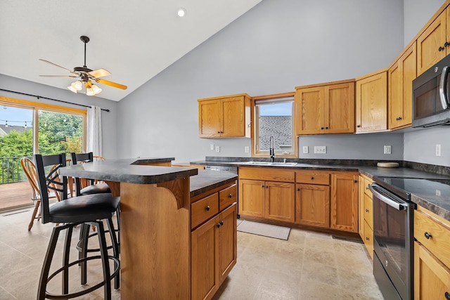 367 Garden Dr, Delano, MN 55328 - kitchen with high vaulted ceiling, dark countertops, a kitchen breakfast bar, black range with electric stovetop, and a kitchen island