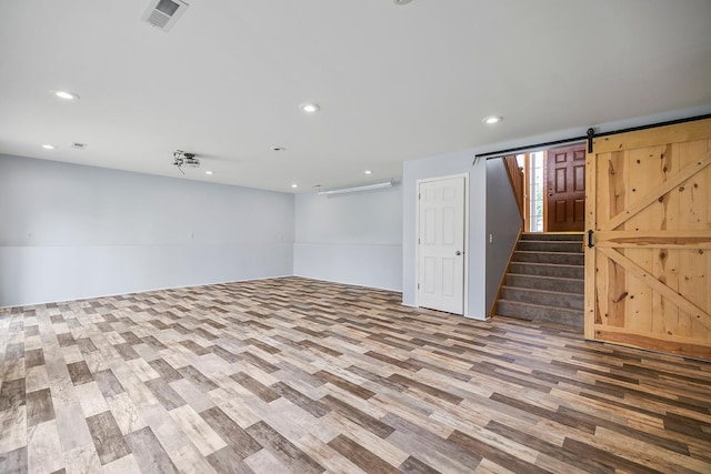 367 Garden Dr, Delano, MN 55328 - below grade area featuring wood finished floors, recessed lighting, a barn door, and stairway