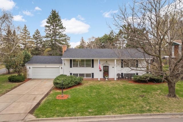 bi-level home featuring a chimney, an attached garage, a shingled roof, concrete driveway, and a front lawn