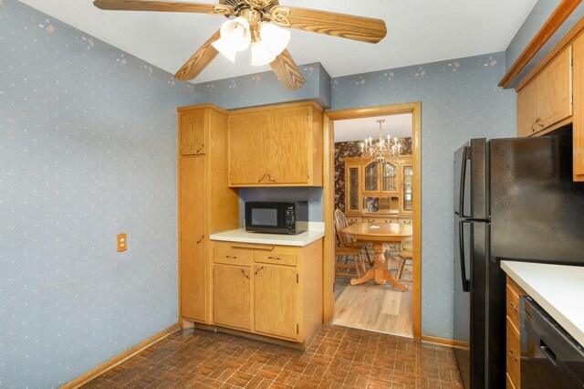 kitchen featuring light countertops, brick patterned floor, black appliances, and wallpapered walls