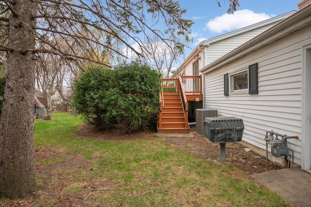view of yard with central air condition unit, stairs, and a wooden deck