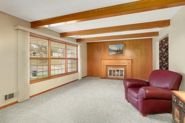 3308 Gate Rd, Saint Anthony, MN 55418 - living area featuring beamed ceiling, carpet floors, a brick fireplace, baseboards, and wood walls