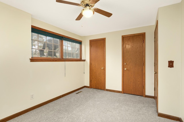 3308 Gate Rd, Saint Anthony, MN 55418 - unfurnished bedroom featuring baseboards, carpet, ceiling fan, and two closets