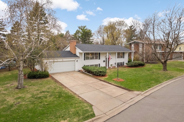 3308 Gate Rd, Saint Anthony, MN 55418 - bi-level home with an attached garage, concrete driveway, a front lawn, and a chimney