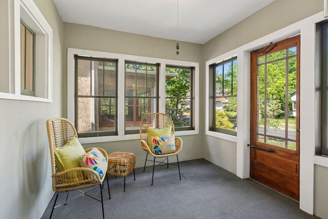 sunroom / solarium with plenty of natural light and carpet floors