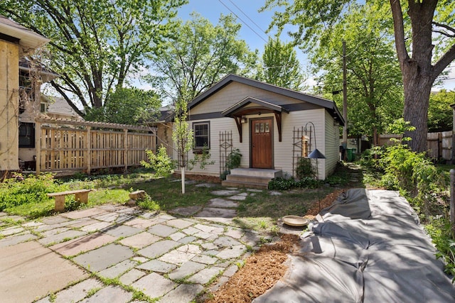 view of front of property with fence and a patio area