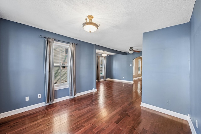 919 6th Ave S, Stillwater, MN 55082 - unfurnished room featuring arched walkways, wood finished floors, a textured ceiling, and a ceiling fan