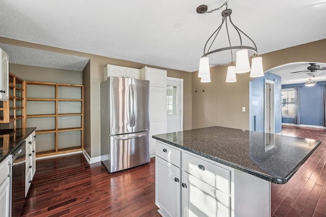 919 6th Ave S, Stillwater, MN 55082 - kitchen with appliances with stainless steel finishes, dark wood finished floors, white cabinetry, and dark stone countertops