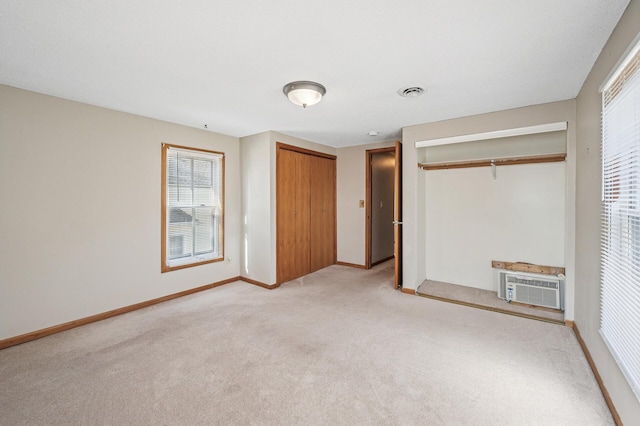 919 6th Ave S, Stillwater, MN 55082 - unfurnished bedroom featuring light colored carpet, multiple windows, and a wall mounted AC